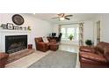 Cozy living room featuring a brick fireplace, bay window, and comfortable leather seating at 2896 Lakemont Sw Dr, Marietta, GA 30060