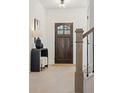 Bright foyer with a dark wooden front door, elegant decor, and a staircase with modern black railings at 2718 Byess Ct, Marietta, GA 30064