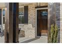 Inviting front porch featuring a stylish dark wooden door, brick facade, and tasteful outdoor seating at 2718 Byess Ct, Marietta, GA 30064