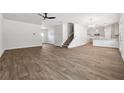 Bright open-concept living room boasts hardwood floors and leads into a kitchen with stainless appliances at 258 Orwell Dr, Social Circle, GA 30025