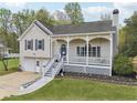 Charming home featuring a covered front porch, well-manicured lawn, and attached two-car garage at 106 Thornwood Dr, Woodstock, GA 30188