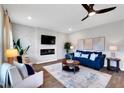 Cozy living room with elegant decor, featuring a ceiling fan, fireplace and modern accents at 319 Overlook Rd, Covington, GA 30014