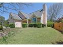 Charming home features a well-manicured front lawn, and an inviting entrance at 2500 Waterstone Way, Marietta, GA 30062