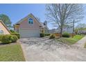 Charming home features a well-maintained front yard and two-car garage at 2500 Waterstone Way, Marietta, GA 30062