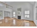 Bright living room boasts a fireplace, tall ceilings, and gleaming hardwood floors at 2500 Waterstone Way, Marietta, GA 30062