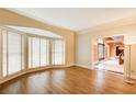 Bright living room with hardwood floors and large bay windows, offering ample natural light and a serene view at 305 Heards Ferry Rd, Atlanta, GA 30328