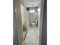 Updated bathroom features a marble-tiled shower, gray tile floors, and a modern toilet at 4844 Fairforest Dr, Stone Mountain, GA 30088