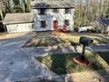 Well-maintained home with a two-car garage and a mailbox, offering a welcoming curb appeal at 4844 Fairforest Dr, Stone Mountain, GA 30088
