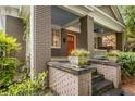Inviting front porch with brick columns, stone steps, and decorative planters at 758 Argonne Ne Ave, Atlanta, GA 30308
