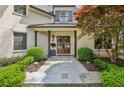 Inviting front entrance with dark wood double doors, stone pathway, and manicured landscaping at 4431 Skyland Ne Dr, Atlanta, GA 30342