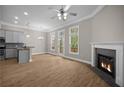 Open concept living room features modern ceiling fan, fireplace, and hardwood floors at 4866 Pinnacle Dr, Stone Mountain, GA 30088