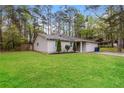 Well-manicured lawn highlights this lovely single-story home with a side view at 8404 Park Ridge Ln, Riverdale, GA 30274