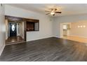 Open-concept living room showcasing hardwood floors and seamless flow to other areas at 8404 Park Ridge Ln, Riverdale, GA 30274