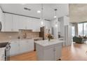 Modern kitchen with white cabinetry, stainless steel appliances, island and an open floor plan at 860 Peachtree Ne St # 1103, Atlanta, GA 30308