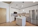 Modern kitchen features white cabinetry, stainless steel appliances and an island at 860 Peachtree Ne St # 1103, Atlanta, GA 30308