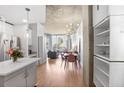 Open floor plan living and dining area with hardwood floors, concrete ceiling, and city views at 860 Peachtree Ne St # 1103, Atlanta, GA 30308