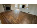 Spacious living room boasting hardwood floors and a classic stone fireplace feature at 99 Fox Ridge Ct, Dallas, GA 30157