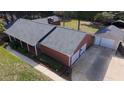 Aerial shot of home, detached garage, and well-maintained yard and driveway at 2533 Whispering Pines Dr, Grayson, GA 30017