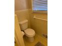Cozy bathroom featuring a standard toilet and a window allowing natural light at 2533 Whispering Pines Dr, Grayson, GA 30017