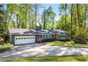 Beautiful single-story home with a well-manicured lawn and a driveway leading to a garage at 3325 N Embry Cir, Atlanta, GA 30341