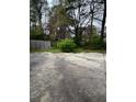 View of the backyard featuring a weathered fence and overgrown shrubbery at 3604 Hopkins Ct, Powder Springs, GA 30127
