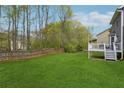 Large backyard with lush green grass and a wood fence perfect for entertaining at 2597 Oak Village Ne Pl, Marietta, GA 30062