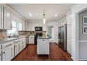 Bright kitchen featuring white cabinets, stainless steel appliances, granite countertops and hardwood floors at 2597 Oak Village Ne Pl, Marietta, GA 30062