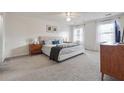 Spacious bedroom with neutral carpet, a ceiling fan, two windows and a walk-in closet at 2597 Oak Village Ne Pl, Marietta, GA 30062
