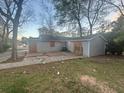View of the backyard featuring a concrete patio, gray siding, and verdant trees at 4262 Lindsey Dr, Decatur, GA 30035