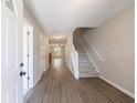 Inviting foyer with hardwood floors, a staircase, and a view into the living area at 6340 Hickory Lane Cir, Union City, GA 30291