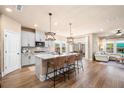 Open kitchen featuring a center island with seating, seamless flow to the living room, and a modern design at 530 Payne Rd, Woodstock, GA 30188