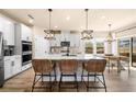 Bright kitchen with a large center island, modern appliances, and stylish pendant lighting at 530 Payne Rd, Woodstock, GA 30188
