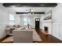 Elegant living room with a fireplace, neutral-toned furniture, and dark wood flooring at 1045 Moreland Se Ave, Atlanta, GA 30316