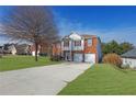 Attractive two-story brick house with a spacious front yard and a long driveway leading to the garage at 3184 Elmwood Ct, Atlanta, GA 30349