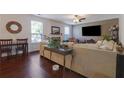 Inviting living room featuring hardwood floors, a fireplace, large windows, and modern furniture, creating a cozy atmosphere at 3184 Elmwood Ct, Atlanta, GA 30349