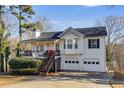 Charming home featuring a covered porch, attached two car garage, and well-maintained landscaping at 674 Fairview Dr, Dallas, GA 30157