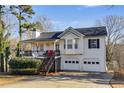 Beautiful home with a covered porch, staircase leading to the entrance, and a two-car garage at 674 Fairview Dr, Dallas, GA 30157