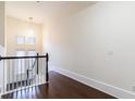 Well-lit hallway with dark hardwood floors and a view of the staircase and windows at 745 Fountainhead Ne Ln # 112, Atlanta, GA 30324