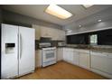 Bright kitchen featuring white appliances, ample countertop space, and plenty of storage, ready for use at 1102 Wedgewood Way, Atlanta, GA 30350