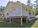 A back exterior featuring a deck and a yard with grassy lawn at 2264 Pryor Rd, Atlanta, GA 30315