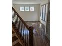 Bright room featuring sleek flooring and large windows, viewed from the staircase at 2499 Sinclair Trce, Powder Springs, GA 30127