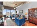 Inviting living room with comfortable seating, exposed ductwork, and city views at 943 Peachtree Ne St # 1910, Atlanta, GA 30309