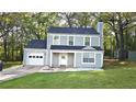 Charming two-story home with light green siding, a well-manicured lawn, and attached garage for modern living at 1276 Seattle Slew Ln, Norcross, GA 30093
