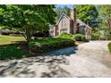 A large driveway leads to a well-maintained home surrounded by lush greenery at 1418 Waterford Green Dr, Marietta, GA 30068