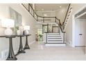 Elegant foyer featuring a grand staircase, tile flooring, and stylish decor at 1418 Waterford Green Dr, Marietta, GA 30068