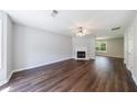 Spacious living room with hardwood floors, a decorative fireplace, ceiling fan, and natural light at 2075 Ivy Ln, Union City, GA 30291