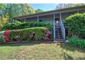 View of house with lush green yard and garden with blooming pink flowers at 5534 Blackhawk Dr, Acworth, GA 30102