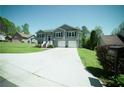 Beautifully landscaped front yard leading up to a charming two-story home at 660 Allens Landing Dr, Lawrenceville, GA 30045