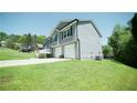 Side view of a well-maintained home with a spacious, green lawn at 660 Allens Landing Dr, Lawrenceville, GA 30045