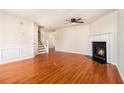 Bright living room with hardwood floors and a cozy fireplace for a comfortable atmosphere at 680 Barshay Dr, Covington, GA 30016